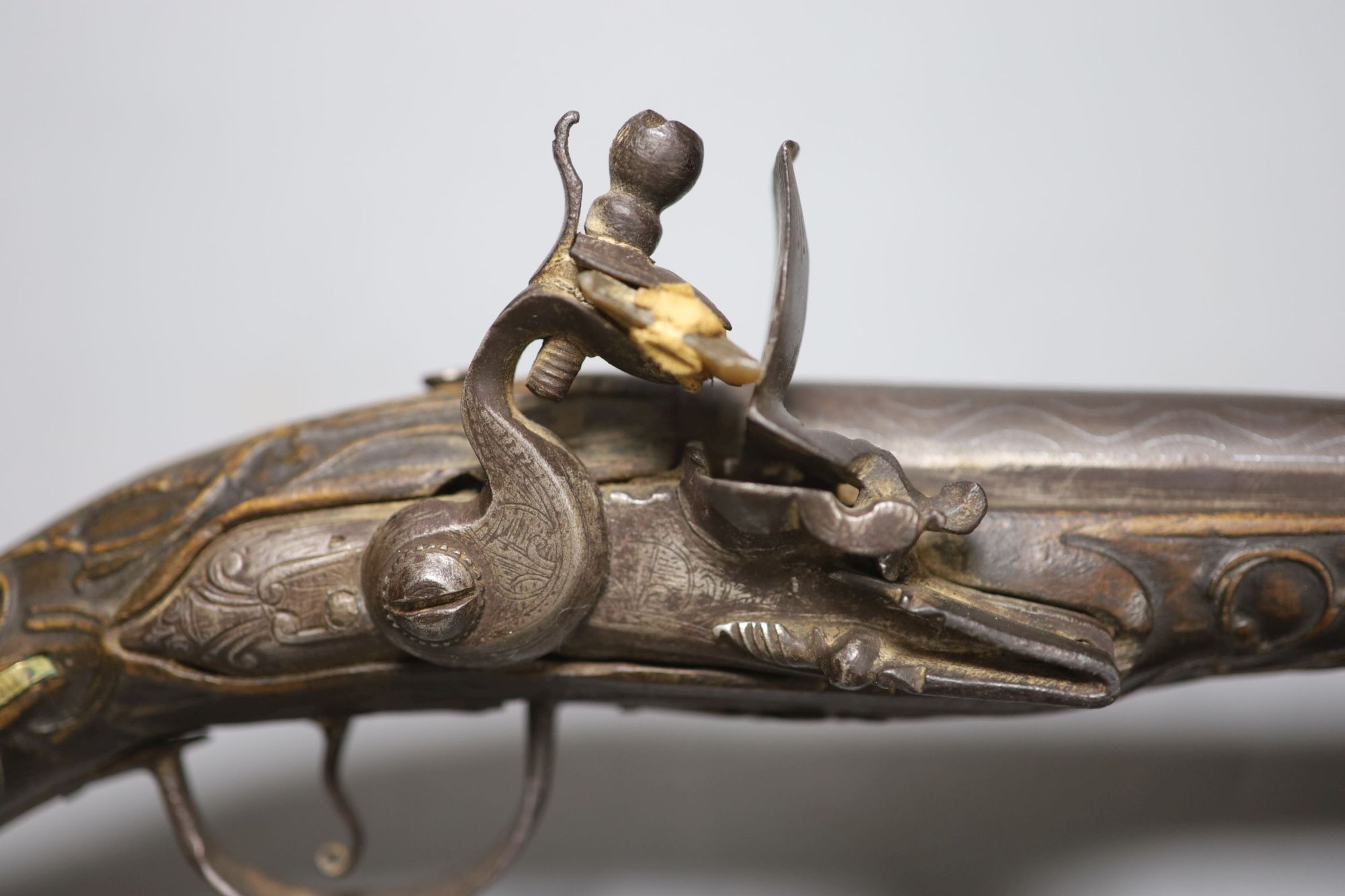 A 19th century Ottoman carved wood and brass mounted flintlock pistol, length 45cm